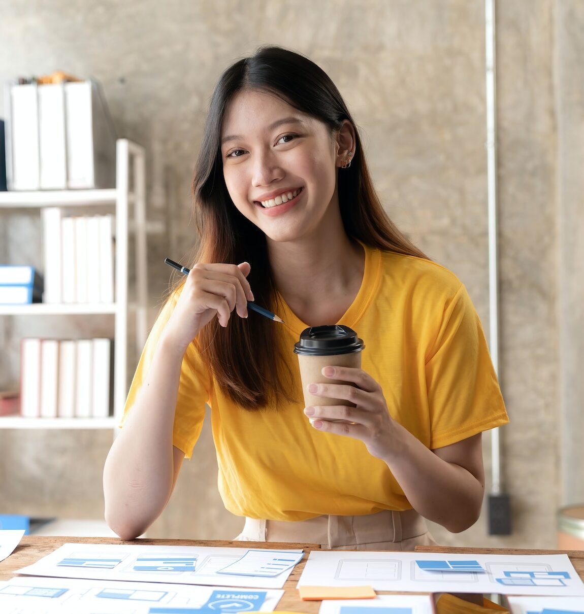 Young asian designer woman drawing a website outline and website ux app development on mobile phone.