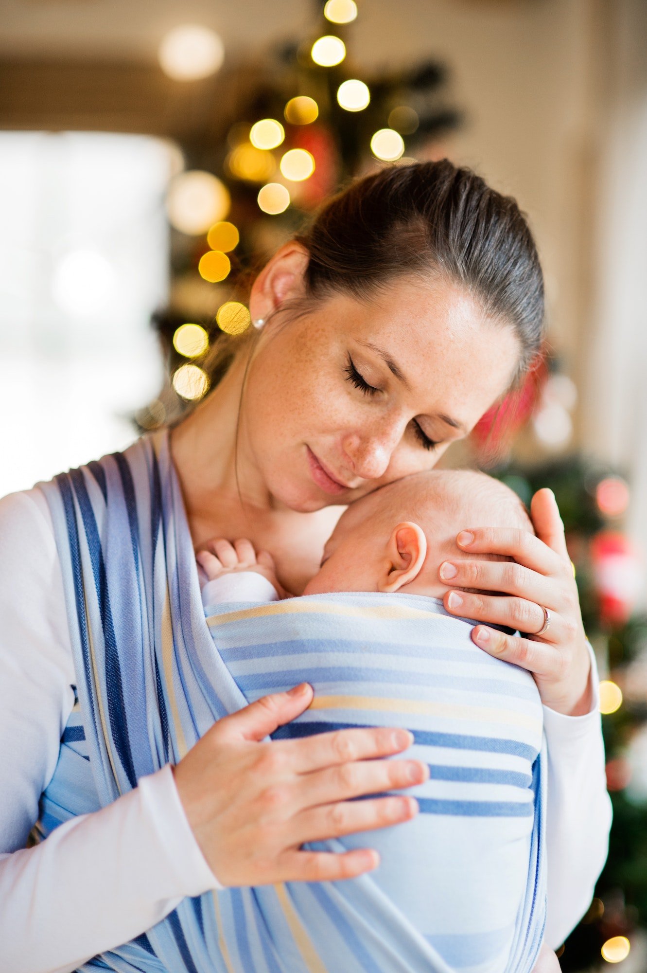 Young woman with a baby boy at Christmas time.